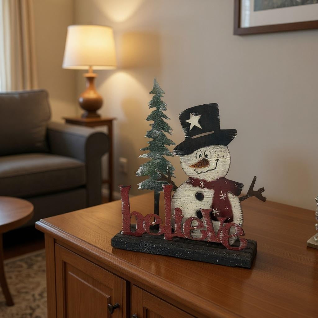 Decorative snowman figure with 'Believe' text on a wooden surface in a living room setting.