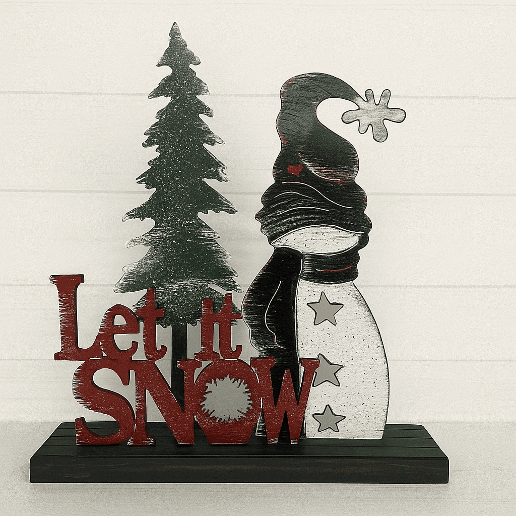 The Custom Holiday Sign Board – Mix & Match Snowman Set includes a wooden Christmas tree, a snowman with a scarf and star buttons, and “Let it Snow” text in red on a black shelf against a white wall.